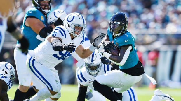 Indianapolis Colts defensive tackle Taven Bryan (96) and teammates try to stop Jacksonville Jaguars running back Travis Etienne Jr. (1) during first quarter action. The Jacksonville Jaguars hosted the Indianapolis Colts at EverBank Stadium in Jacksonville, FL Sunday, October 15, 2023. The Jaguars ended the first half with a 21 to 6 lead. [Bob Self/Florida Times-Union]